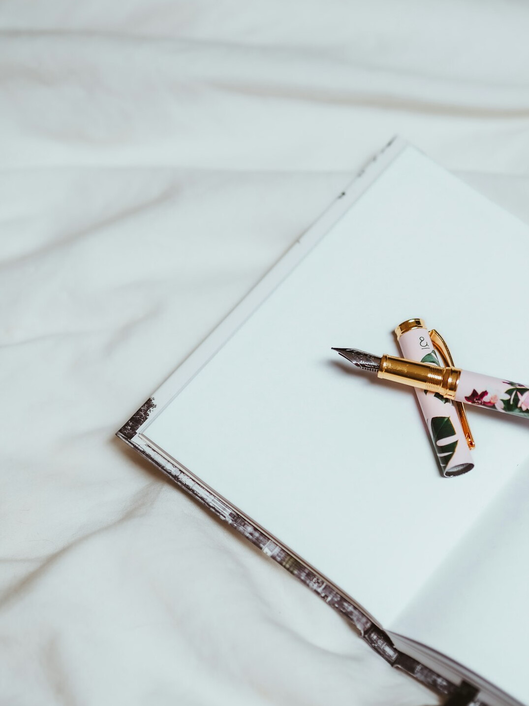 Open notebook with handwritten notes and a pen