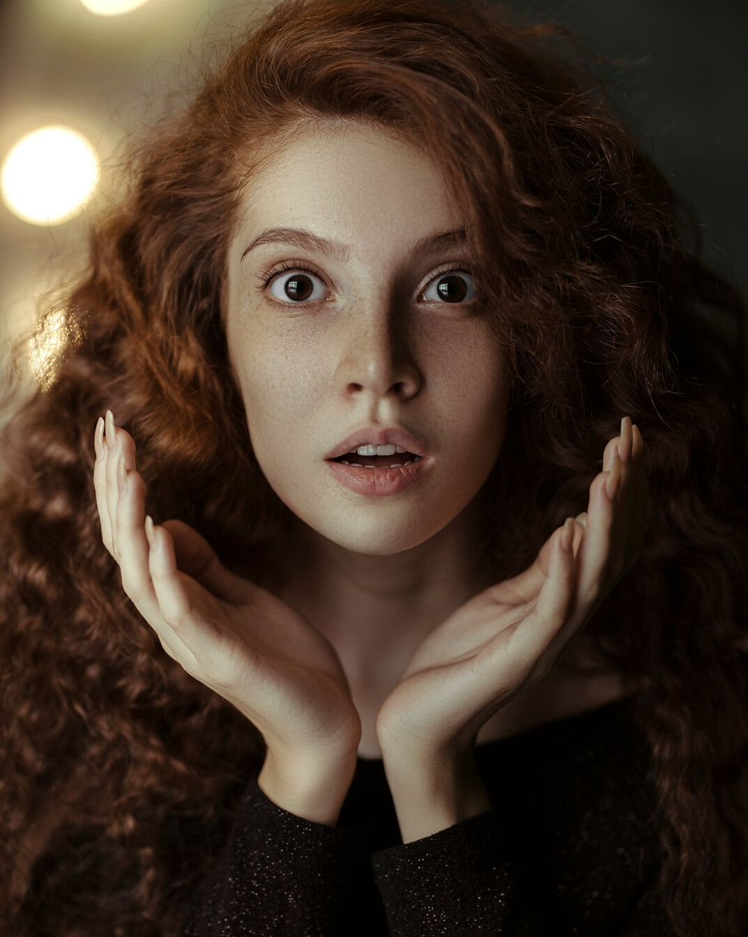 Studio portrait of a young woman with curly hair