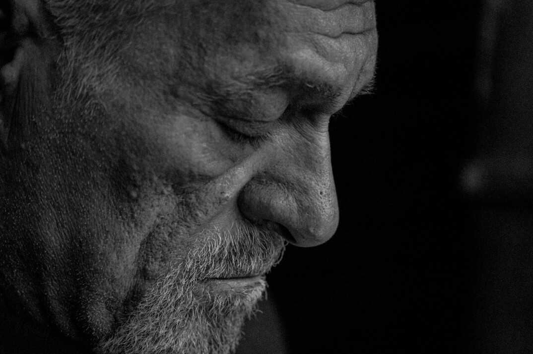 Studio portrait of an older man with grey hair
